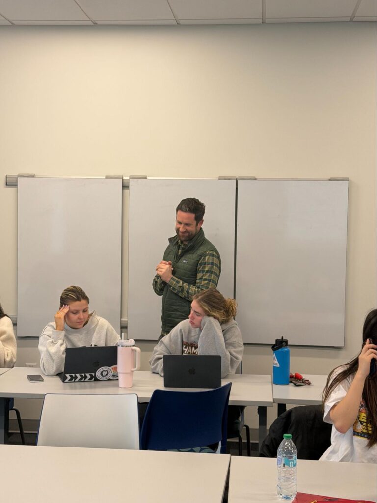 Teacher assists students in classroom setting