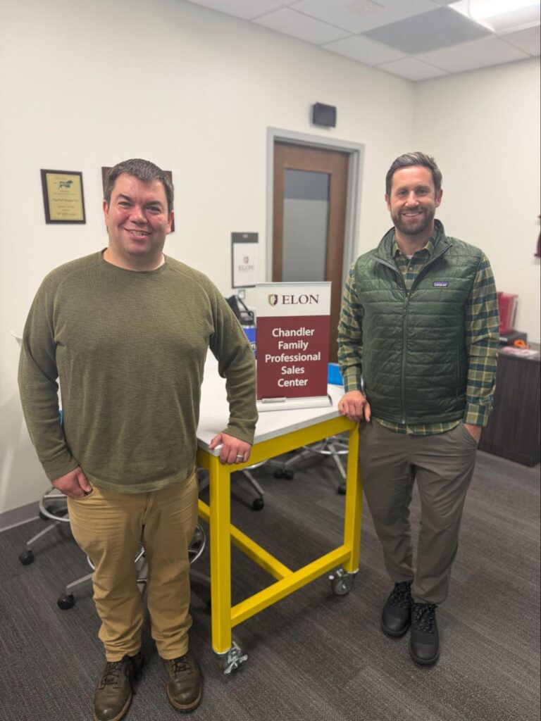 Two men at Elon University sales center.